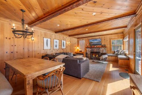 a living room with a couch and a table at Spacious, Central, & Cozy Cabin Near Lake & Trails in Carnelian Bay