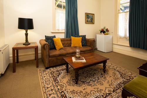 a living room with a couch and a coffee table at Leura House in Leura