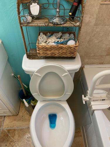 a bathroom with a toilet with baskets on top of it at Cozy room near Airport & Highway in Saint Louis