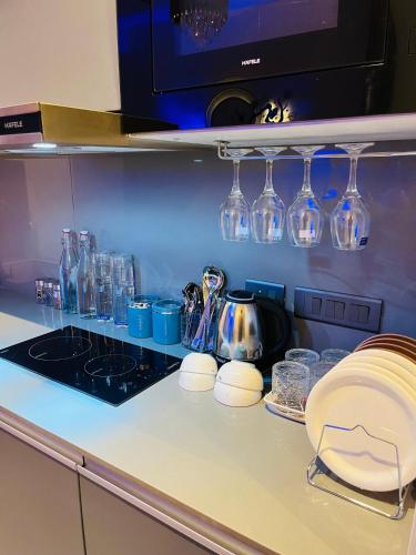 a kitchen counter with glasses on a counter top at The Luxury Lodge in Noida