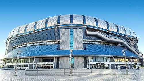 a large round building with a blue roof at Toyoko Inn Osaka Nippombashi Bunraku Gekijo Mae in Osaka