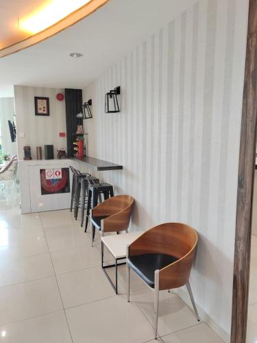a restaurant with chairs and a counter in a room at BG Business Hotel in Bukit Mertajam