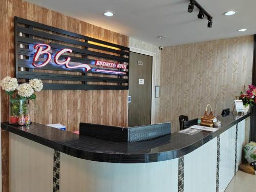 a lobby with a bar with a sign on the wall at BG Business Hotel in Bukit Mertajam