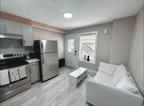 a living room with a couch and a kitchen at Modern Guest Suite in Vancouver in Vancouver