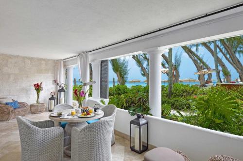 a living room with a table and chairs at Colony Club, a Luxury Collection Resort, Barbados in Saint James