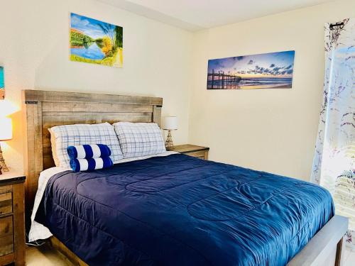 a bedroom with a bed with a blue comforter at Spacious Condo close to Siesta in Sarasota