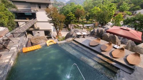 an indoor swimming pool with a water slide at The Bluestone Lodge in Ha Giang