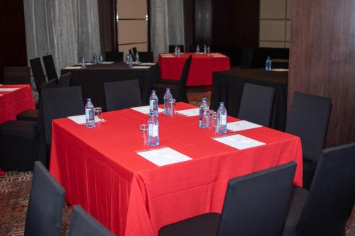 a table with a red table cloth and black chairs at Crowne Plaza Nairobi Airport by IHG in Nairobi