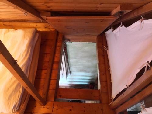 an attic room with two beds and a window at Zum Waldmeister in Schkeuditz