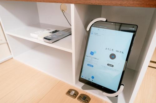 an apple iphone hanging from a shelf at Simple Stay Minoshima セルフチェックイン in Fukuoka
