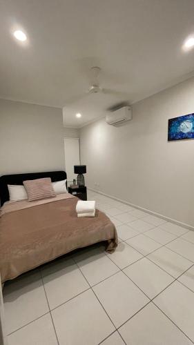 a bedroom with a bed and a painting on the wall at There Is No Place Like Home in Stuart Park