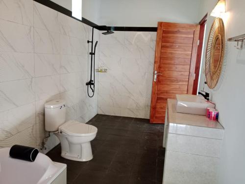a bathroom with a toilet and a sink at Private Villa Aditya Beach in Buleleng
