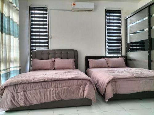 two beds sitting next to each other in a room with windows at IRIS 31 Corner Lot Near Legoland JDT UTM Malay Only in Johor Bahru