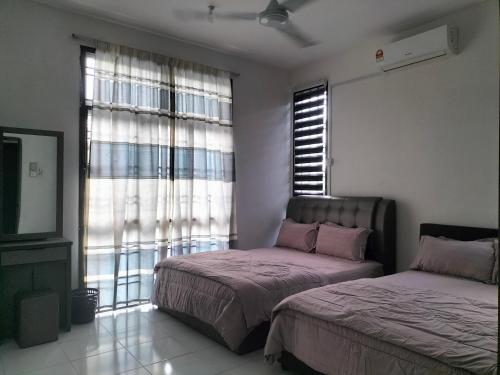 a bedroom with two beds and a window at IRIS 31 Corner Lot Near Legoland JDT UTM Malay Only in Johor Bahru