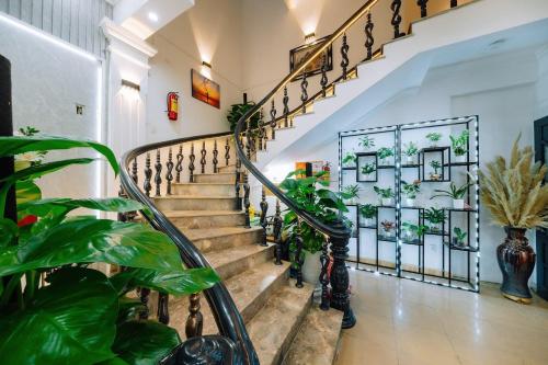 a staircase in a house with plants at Harry Homestay in Cat Ba