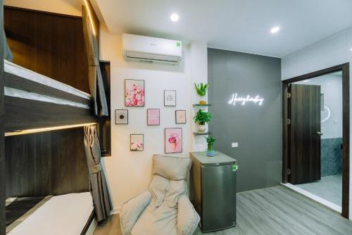 a dorm room with a bunk bed and a chair at Harry Homestay in Cat Ba