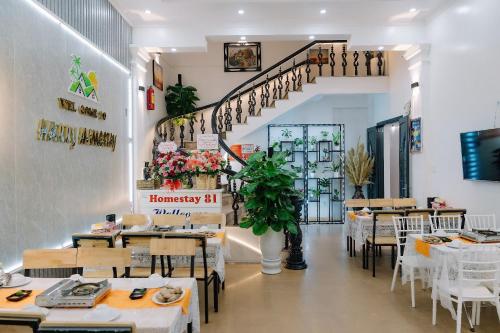 a restaurant with tables and chairs and a staircase at Harry Homestay in Cat Ba