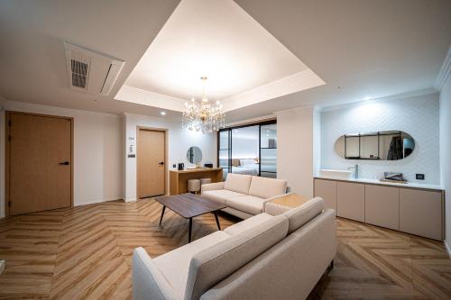 a living room with a couch and a table at H Avenue Gumi Okgye in Gumi