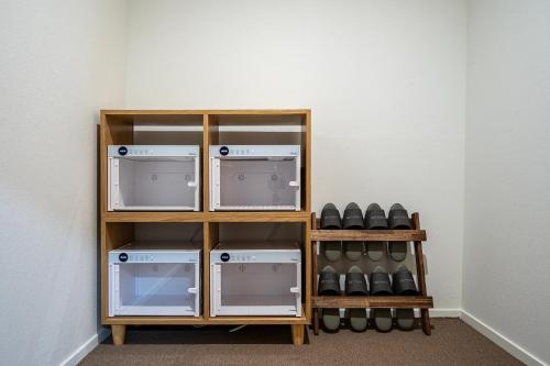 a shelf with four machines in a room at H Avenue Gumi Okgye in Gumi