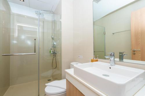 a bathroom with a sink and a shower and a toilet at W3 Hotel in Hat Yai