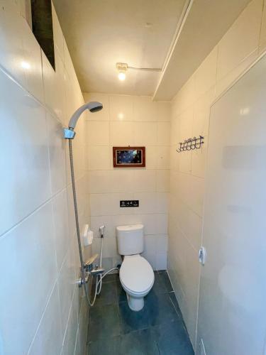 a bathroom with a toilet and a shower at VILLACANTIK Yogyakarta triple bed for six persons in Bantul