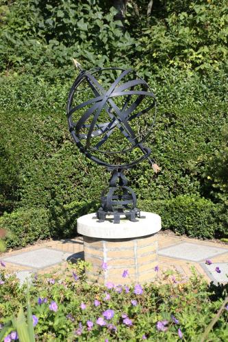 a statue of a windmill in a garden at Logies Ternier in Nieuwpoort