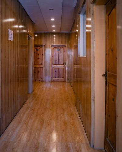 an empty hallway with wooden walls and doors at K2 Paradise Guest house in Skardu