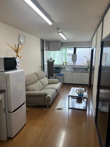 a living room with a couch and a table at ｊR蒲田駅1分空港近い in Tokyo
