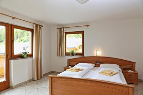 a bedroom with a bed with two towels on it at Ferienhaus Berger in Sarntal