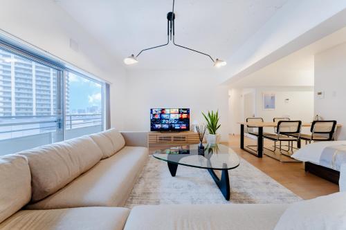 a living room with a couch and a table at SAKURA Residence目黒駅前 Junior Suite in Tokyo
