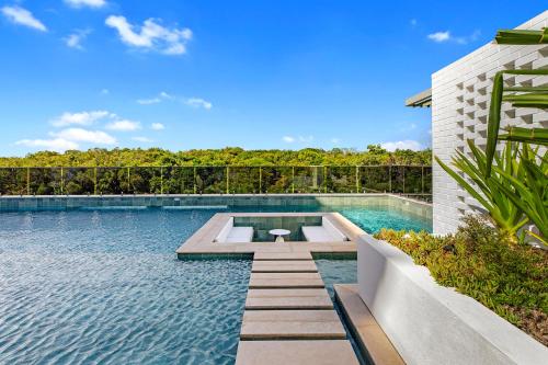 a swimming pool in the middle of a house at Seanna Residences Bokarina Beach in Kawana Waters