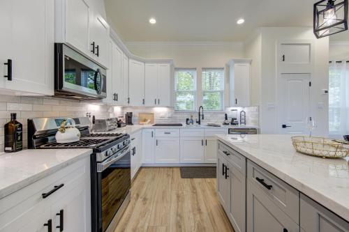 a kitchen with white cabinets and a stove top oven at Exquisite House with rooftop in Houston in Houston