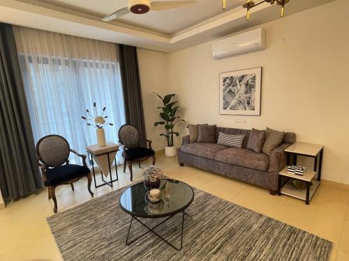 a living room with a couch and a table at 1 Bedroom Furnished Apartment at Eighteen Islamabad in Islamabad
