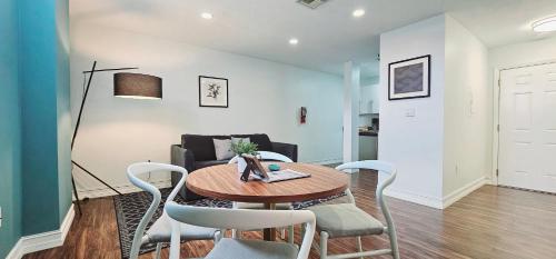 a living room with a table and chairs and a couch at Walk to Everything From The Lofts Suite 307 in West Palm Beach