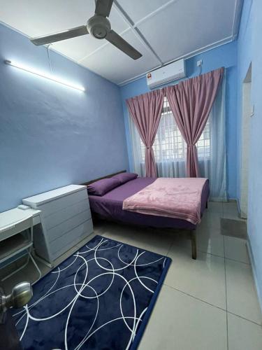a bedroom with a bed and a ceiling fan at Homestay Haris nearby USIM in Nilai