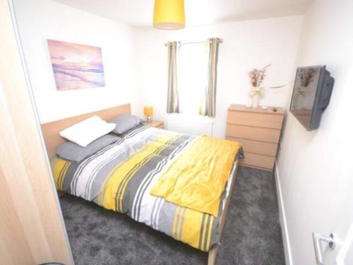a bedroom with a bed and a tv in it at Cove Hideaway 1bhk Apt 10 in Skinningrove in Skinningrove