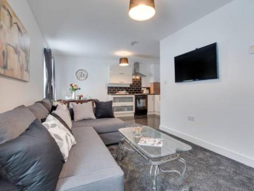 a living room with a couch and a table at Cove Hideaway 1bhk Apt 10 in Skinningrove in Skinningrove