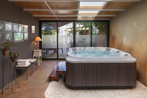 a large hot tub in a room with a patio at Casa Rural Can Coll in Garriguella