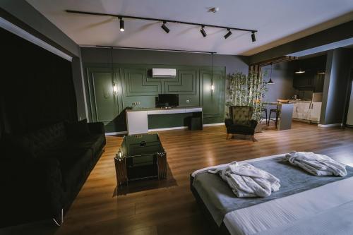 a bedroom with a bed and a living room at ENNA SUIT HOTEL in Nilüfer