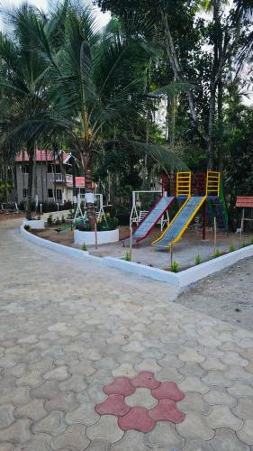 a playground with a slide in a park at Areca ranches home stay in Chikmagalūr