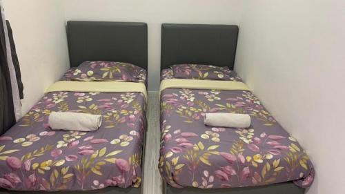 two beds sitting next to each other in a room at Sutera Avenue Kota Kinabalu in Kota Kinabalu