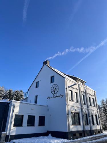 a white building with snow on the ground at Haus Kuckenberg in Burscheid