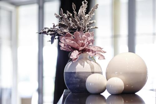 a vase with flowers and eggs on a table at nordica Hotel Berlin in Heide