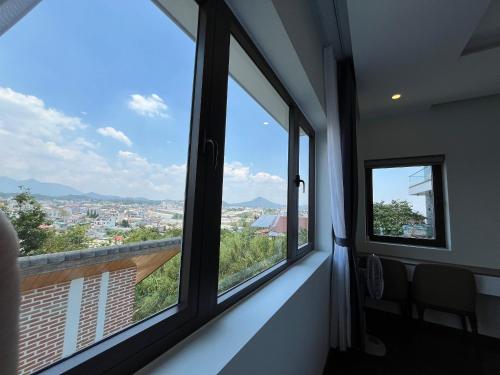 a room with windows with a view of a city at SAFFRON Dalat in Da Lat