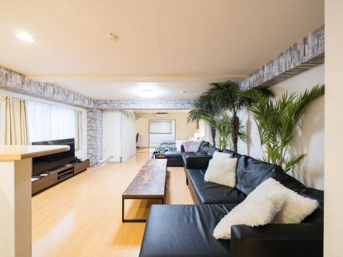 a living room with couches and a tv at Shinjuku, 1min walk from Kagurazaka Sta,80sqm,Family-Friendly, in Tokyo