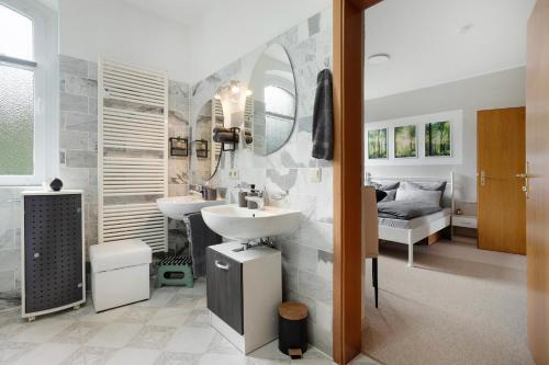 a bathroom with a sink and a mirror at Fewo zum alten Bahnhof 