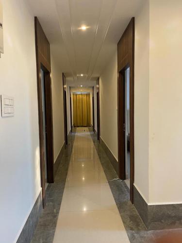 a hallway of a building with a yellow door at SNR VENUS HOTELS in Tirupati