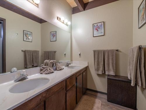 a bathroom with two sinks and a large mirror at Rooted Resort in Kings Beach