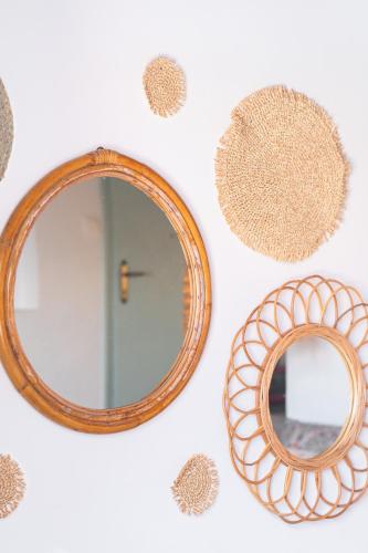 a group of mirrors on a wall with a mirror at Alfa Loft (by Lemon Tree Houses) in Vrahati
