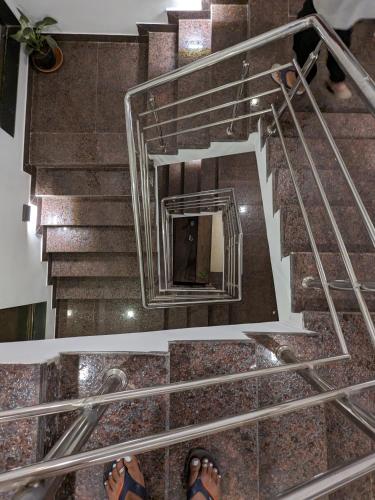 a person standing on the stairs in a building at Hotel and Villa Samarth Palace in Panchgani